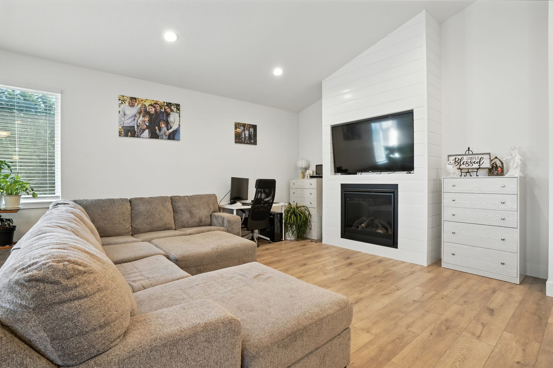 Living room with vaulted ceiling and fireplace