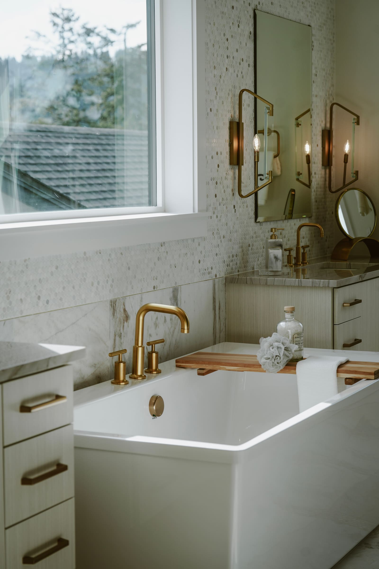 Spa-style bathroom with soaking tub and brass fixtures
