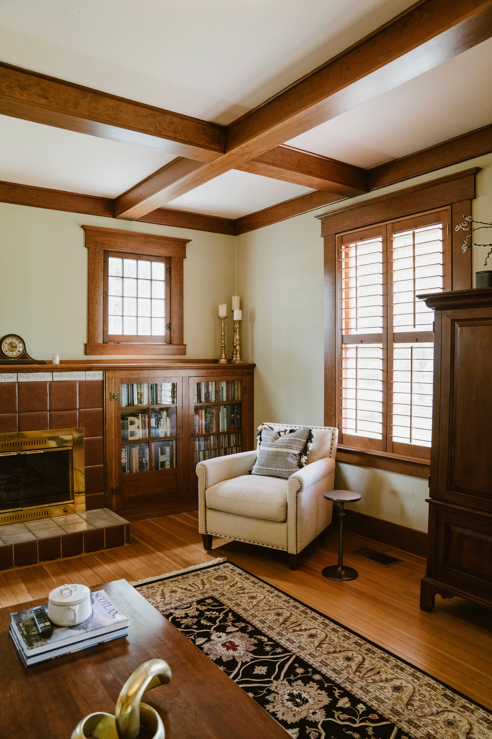 Warm craftsman-style living room with fireplace and built-in bookcases